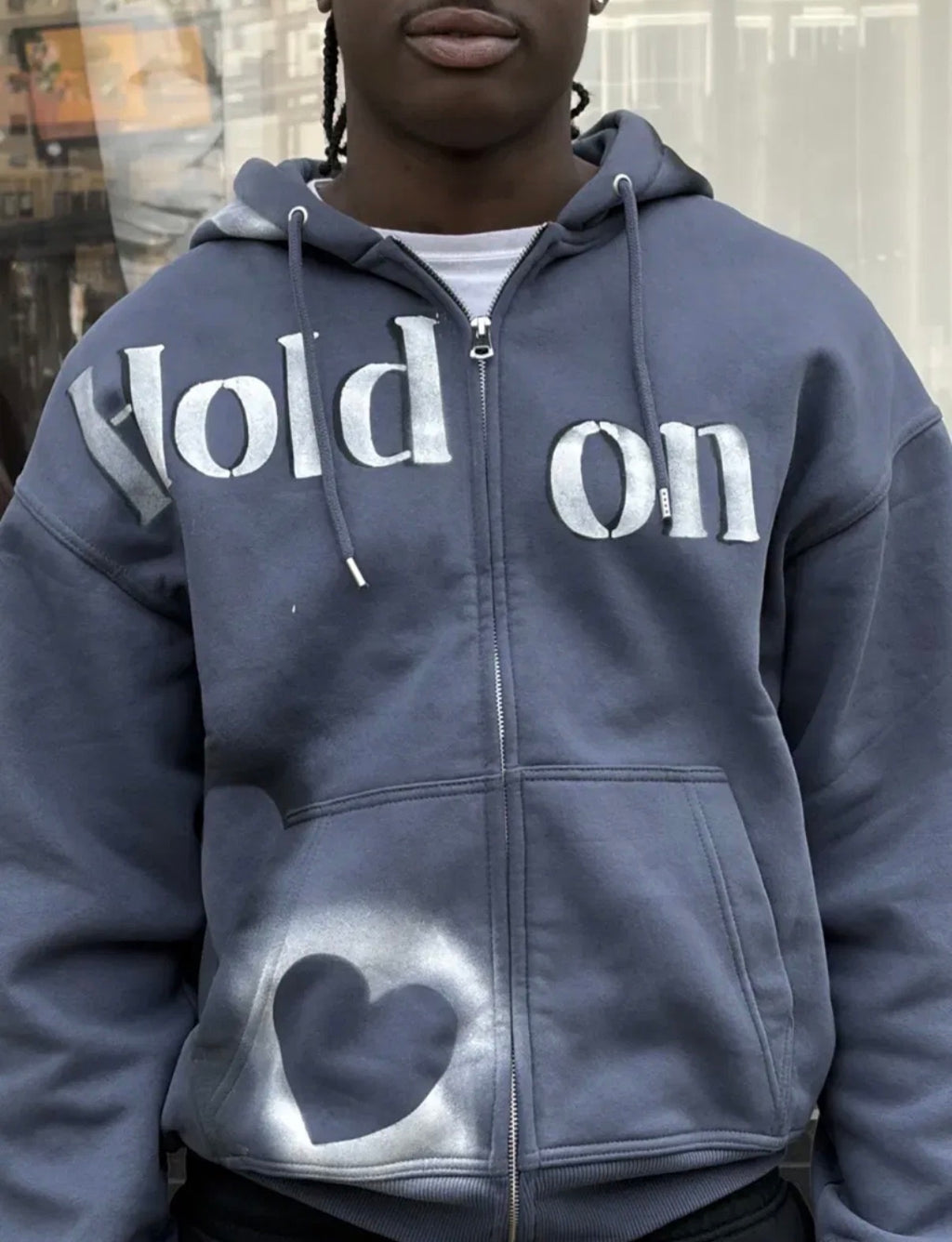 Close-up of Hold On Clothing blue zip hoodie with heart graphic