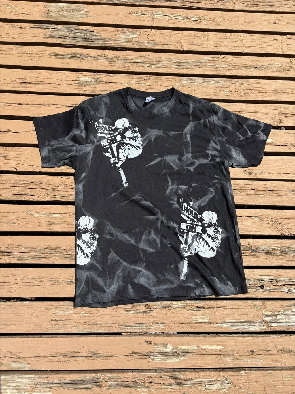 Front of Hold On Shadow Graphic Tee laid flat on wooden deck